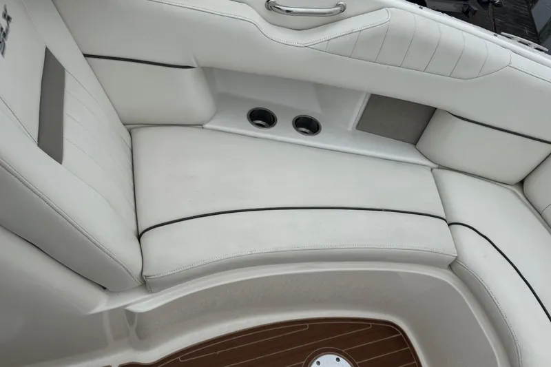 Slide: The Image of 2007 Sea Ray 270 SLX boat interior with white cushioned seating and wood flooring. - 18