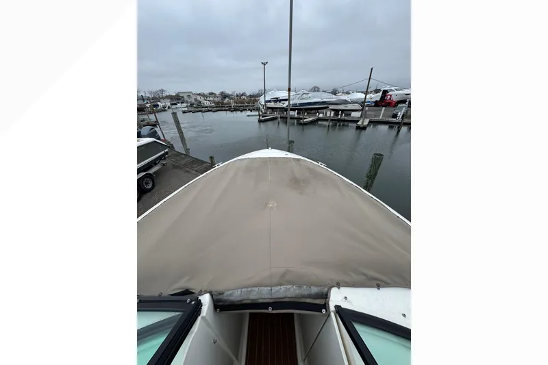 Slide: The Image of 2007 Sea Ray 270 SLX boat docked at marina on a cloudy day. - 20