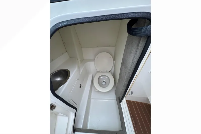 Slide: The Image of 2007 Sea Ray 270 SLX boat bathroom with toilet and sink. - 21