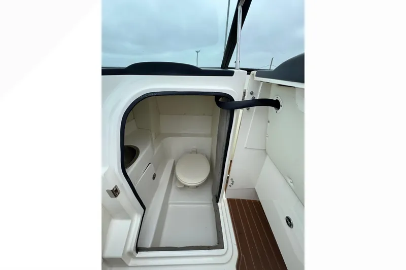 Slide: The Image of 2007 Sea Ray 270 SLX boat interior with compact marine toilet. - 23