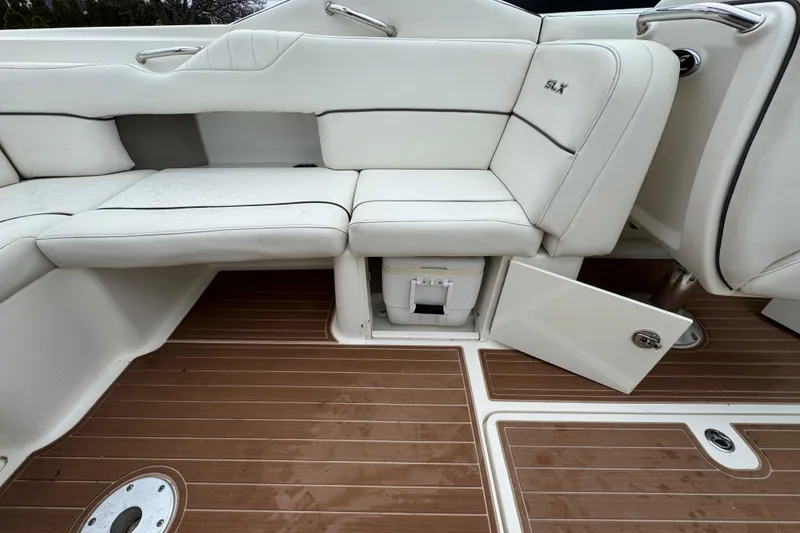 Slide: The Image of 2007 Sea Ray 270 SLX boat interior with white seating and open storage compartment. - 25