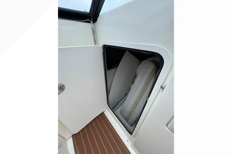 Slide: The Image of Storage compartment on a 2007 Sea Ray 270 SLX boat, featuring a wooden floor. - 26