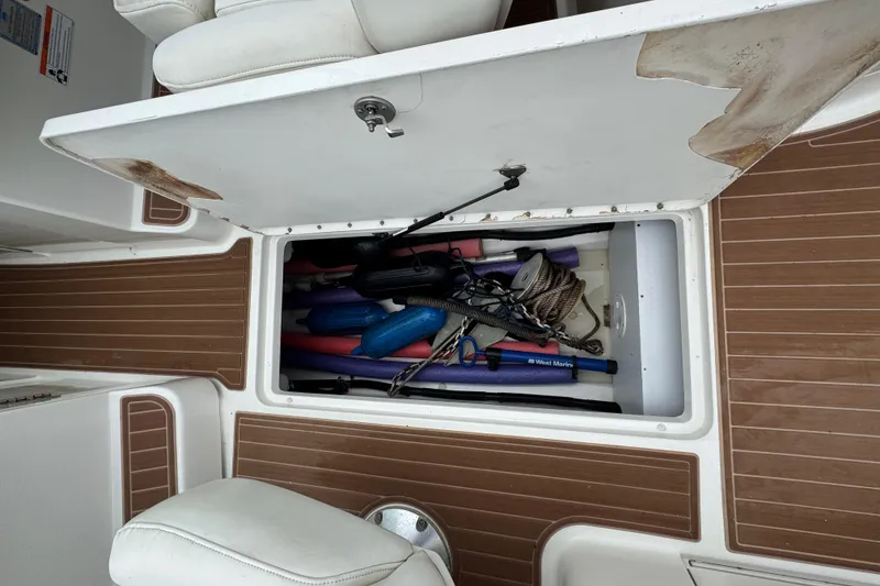 Slide: The Image of Storage compartment on a 2007 Sea Ray 270 SLX boat with various boating accessories. - 27