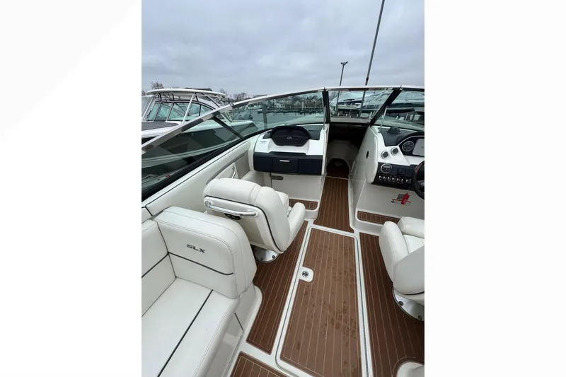 Slide: The Image of 2007 Sea Ray 270 SLX boat interior with white seating and wood flooring. - 28