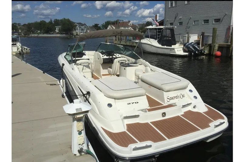 Slide: The Image of 2007 Sea Ray 270 SLX boat docked at marina under clear skies. - 3