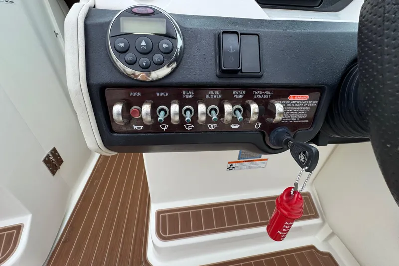 Slide: The Image of Control panel of a 2007 Sea Ray 270 SLX boat with switches and key. - 30