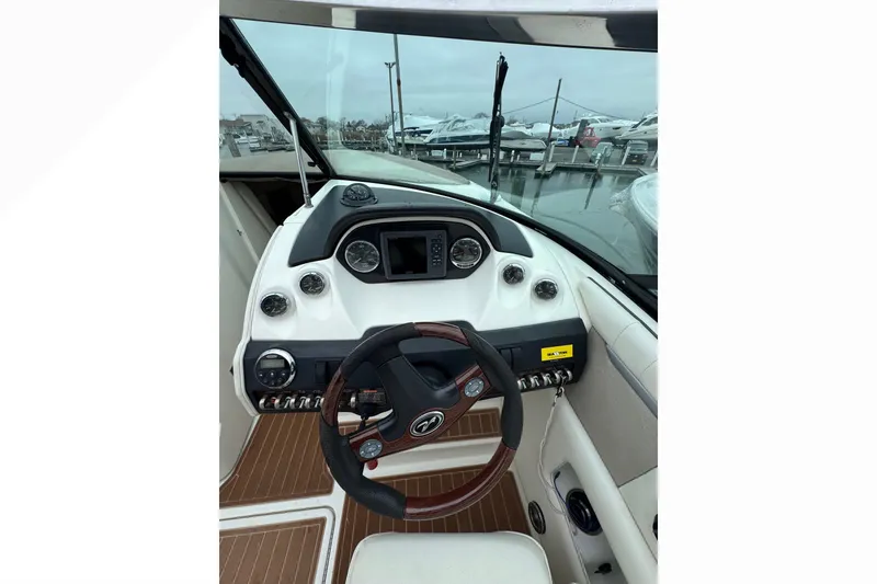 Slide: The Image of 2007 Sea Ray 270 SLX boat dashboard with steering wheel and control panel. - 32