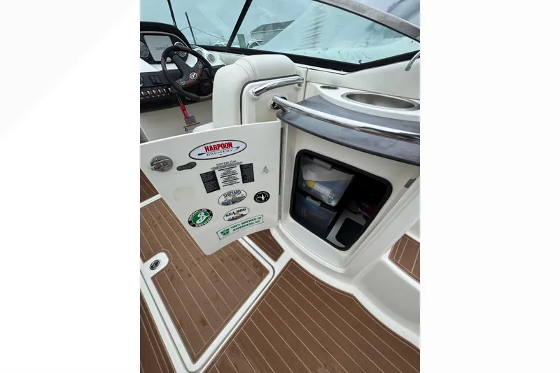Slide: The Image of 2007 Sea Ray 270 SLX boat interior with open storage compartment and dashboard view. - 33
