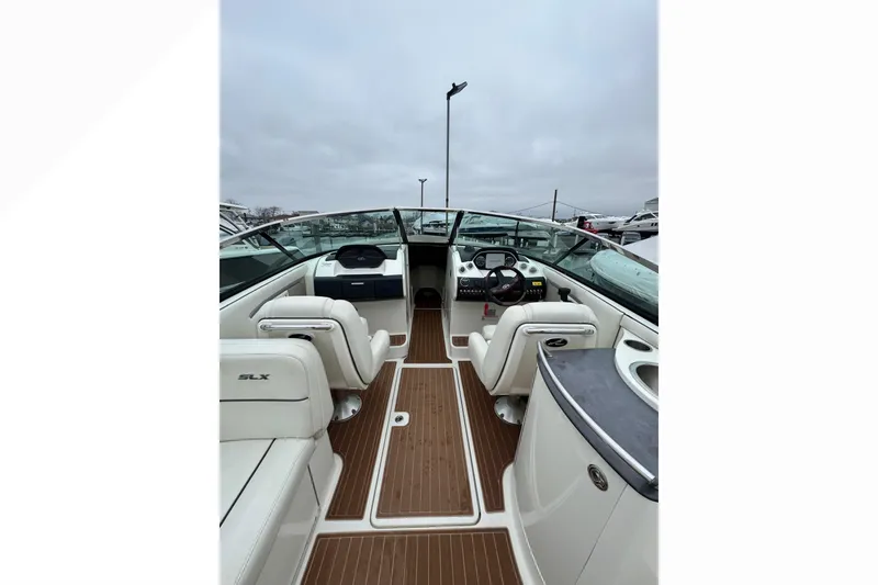 Slide: The Image of 2007 Sea Ray 270 SLX boat interior with white seating and wooden flooring. - 34