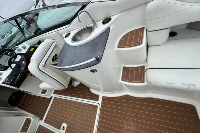 Slide: The Image of Interior of 2007 Sea Ray 270 SLX boat with helm, sink, and seating. - 35