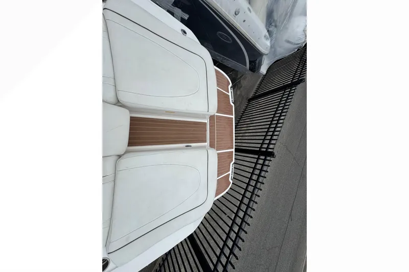 Slide: The Image of 2007 Sea Ray 270 SLX boat with white seating and wooden deck, viewed from above. - 36