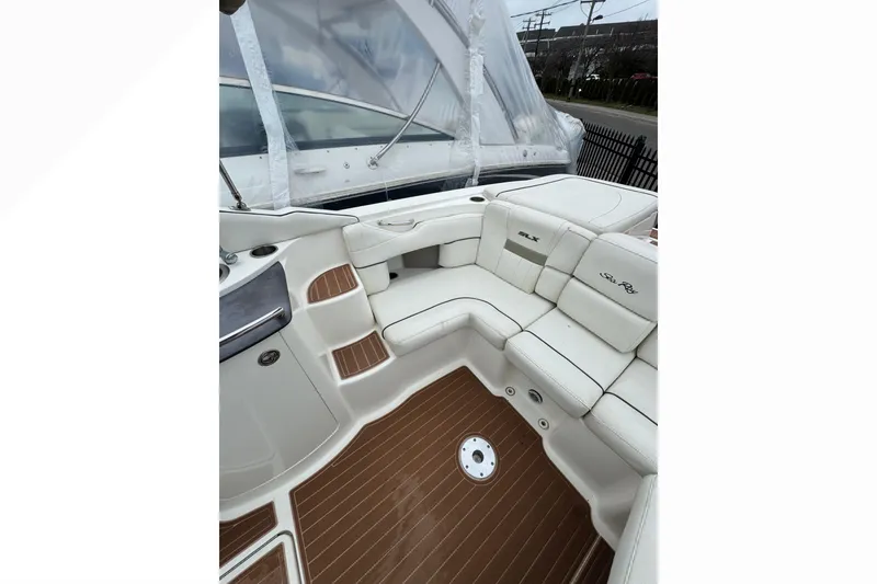 Slide: The Image of 2007 Sea Ray 270 SLX boat interior with white seating and wood-style flooring. - 37