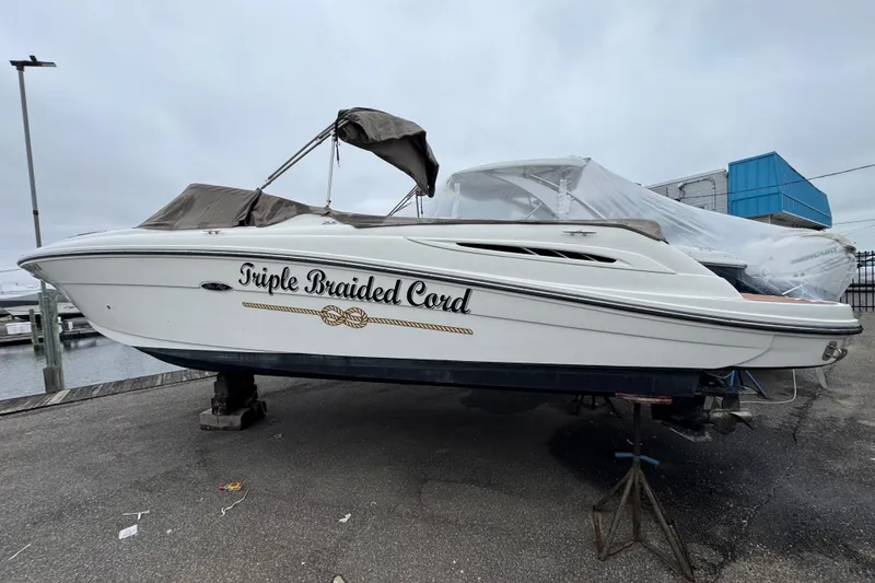 Slide: The Image of 2007 Sea Ray 270 SLX boat named "Triple Braided Cord" on dry dock. - 6