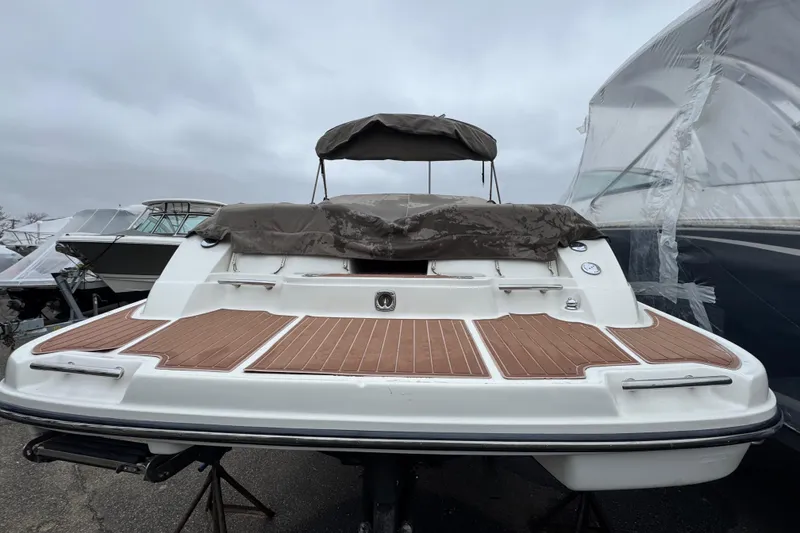 Slide: The Image of 2007 Sea Ray 270 SLX boat with covered deck, docked outdoors. - 7