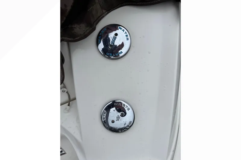 Slide: The Image of 2007 Sea Ray 270 SLX boat water and waste caps on white surface. - 8