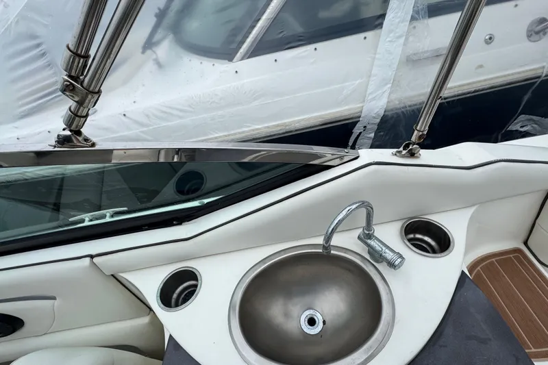 Slide: The Image of 2007 Sea Ray 270 SLX boat interior with sink and cup holders. - 9