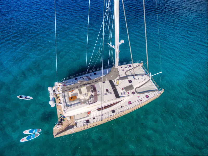Slide: The Image of Aerial view of 2010 Privilege 745 yacht anchored in clear blue water. - 14