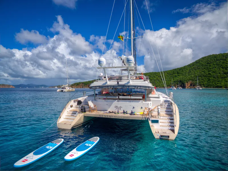 Slide: The Image of Luxury Privilege 745 yacht anchored in clear blue waters with paddleboards, 2010 model. - 17