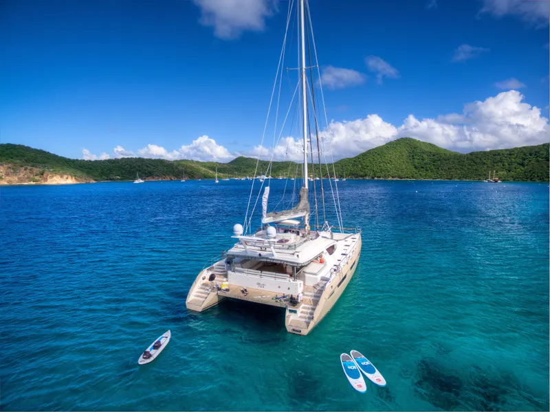 Slide: The Image of Luxury Privilege 745 yacht anchored in clear blue waters, surrounded by paddleboards, 2010 model. - 3