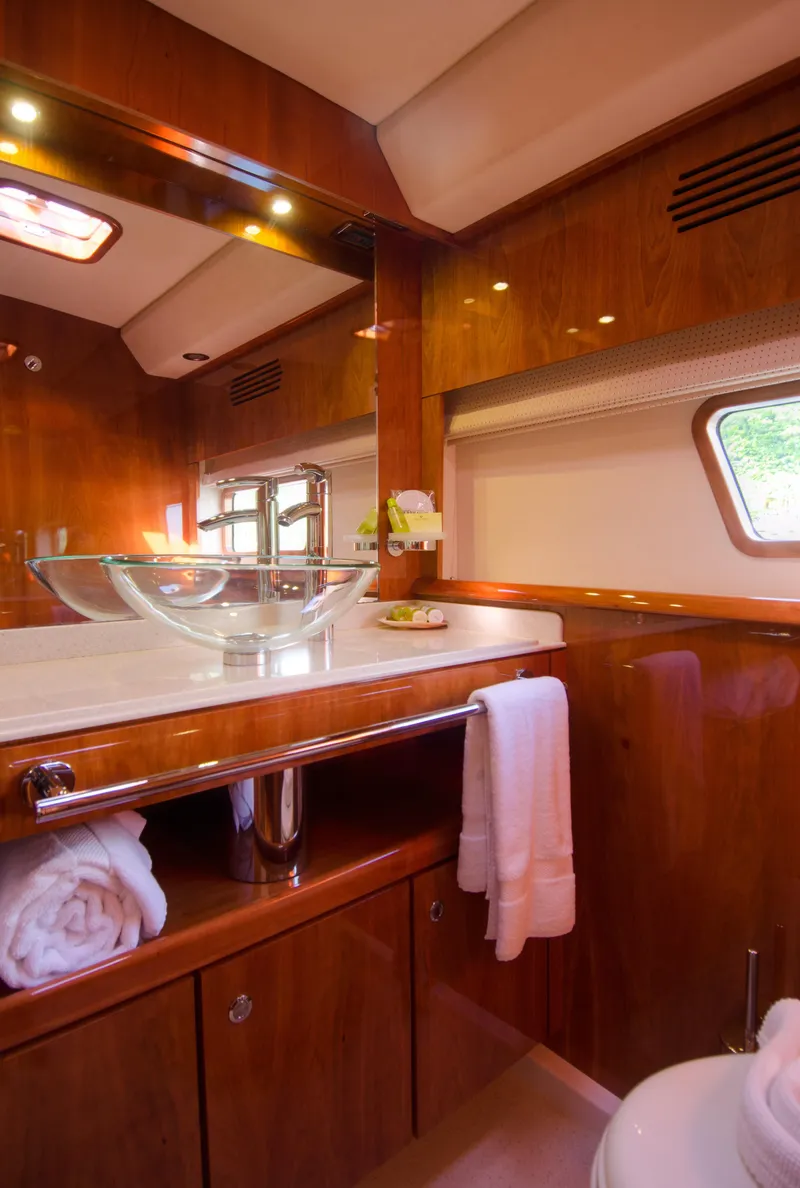 Slide: The Image of Luxurious bathroom on a 2010 Privilege 745 yacht with wooden cabinetry and glass sink. - 38