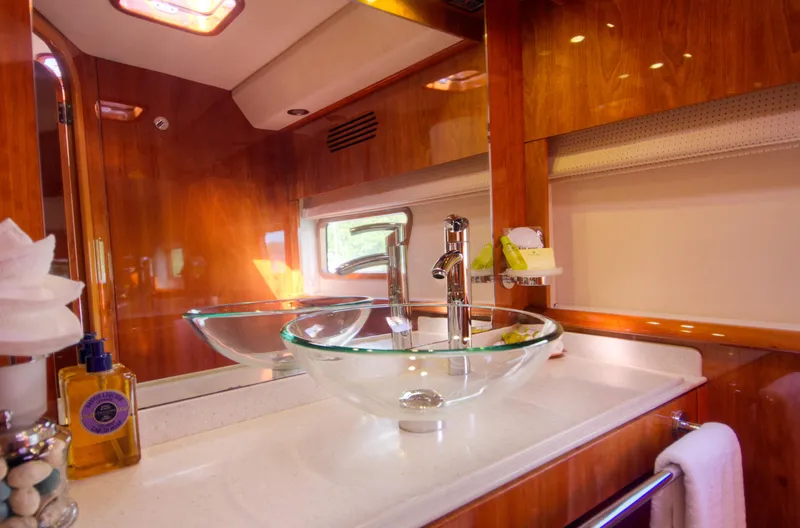 Slide: The Image of Luxurious bathroom in 2010 Privilege 745 yacht with glass sink and wooden finish. - 39