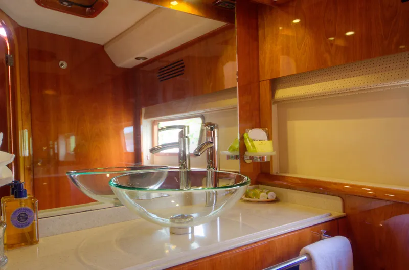 Slide: The Image of Luxurious bathroom in a 2010 Privilege 745 yacht with glass sink and wooden finishes. - 41