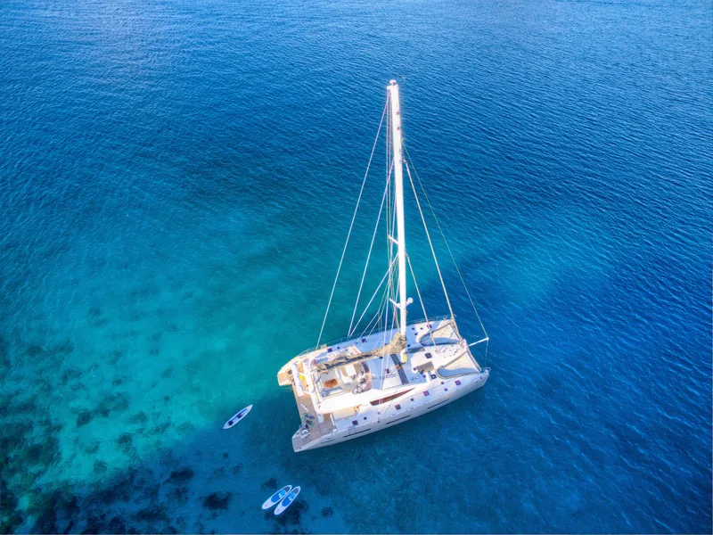 Slide: The Image of Aerial view of 2010 Privilege 745 yacht anchored in clear blue waters. - 7