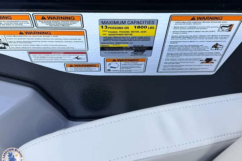 Slide: The Image of Warning labels and capacity information on a 2026 Premier 220 Sunscape RF boat. - 13