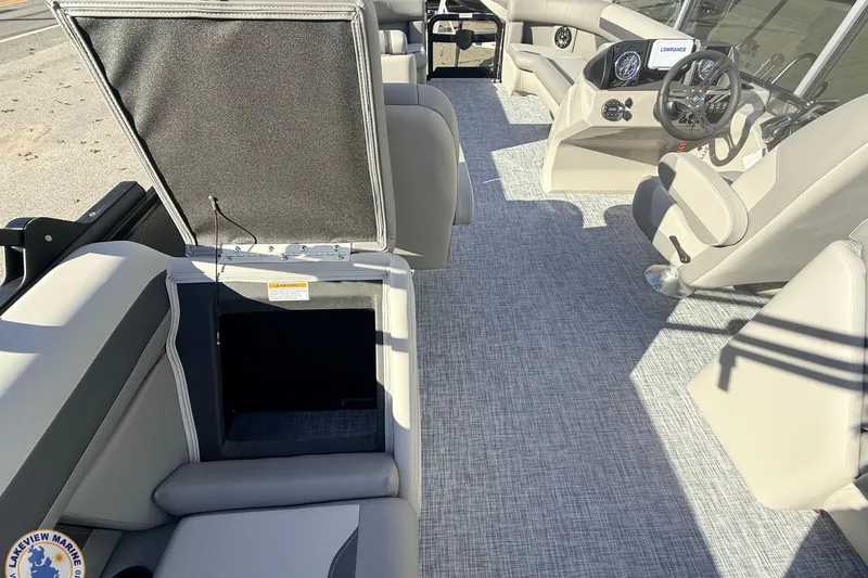 Slide: The Image of 2026 Premier 220 Sunscape RF boat interior with open storage compartment and modern helm. - 7