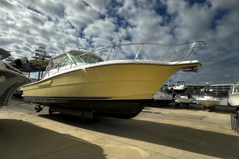The Image of 2003 Rampage 38 Express boat on dry dock under cloudy sky. - 1