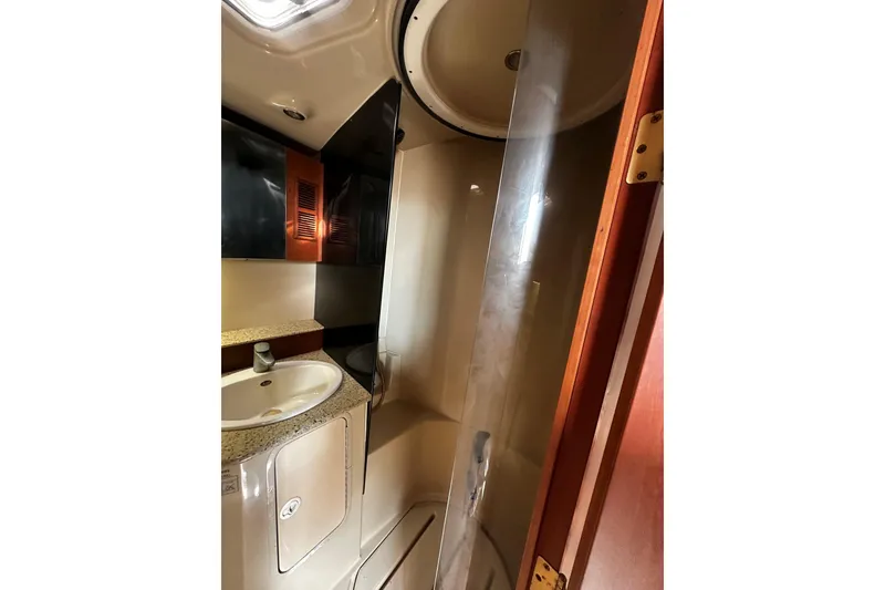 Slide: The Image of 2003 Rampage 38 Express bathroom with sink, shower, and storage cabinets. - 10