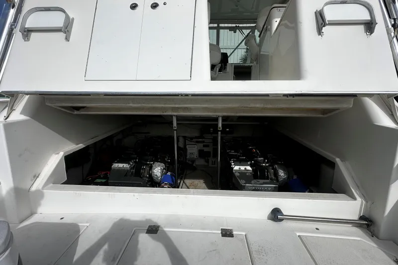 Slide: The Image of Engine compartment of a 2003 Rampage 38 Express boat, showcasing dual engines. - 18