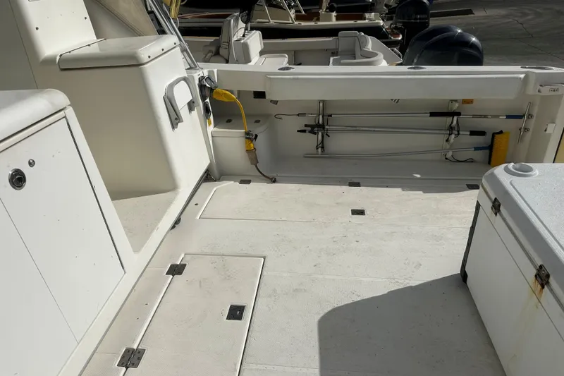 Slide: The Image of 2003 Rampage 38 Express boat deck with storage compartments and fishing gear. - 19