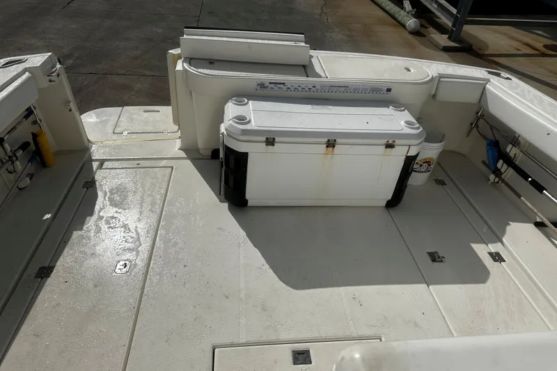 Slide: The Image of 2003 Rampage 38 Express boat deck with cooler and fishing equipment. - 20