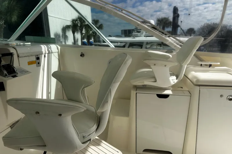 Slide: The Image of 2003 Rampage 38 Express boat interior with white seating and control panel. - 21