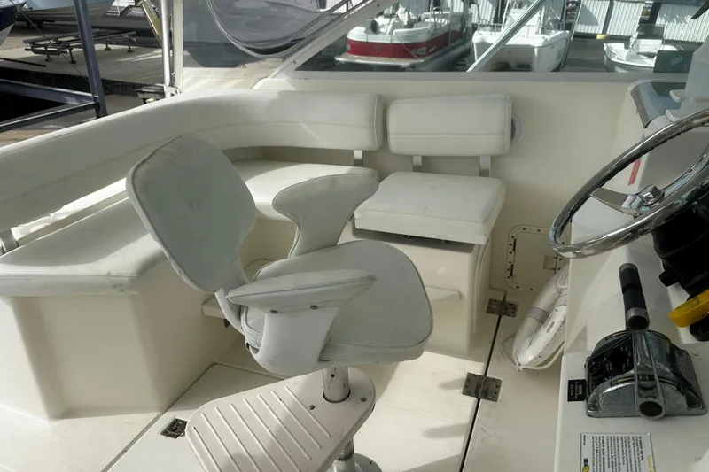 Slide: The Image of 2003 Rampage 38 Express boat cockpit with white seating and steering wheel. - 22