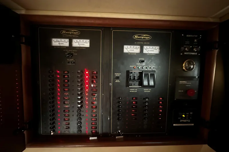 Slide: The Image of Electrical control panel of a 2003 Rampage 38 Express boat, featuring switches and gauges. - 6