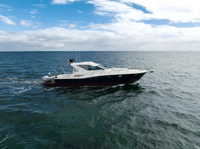 The Image of 2001 Uniesse 48 Open yacht cruising on open water under a partly cloudy sky. - 0