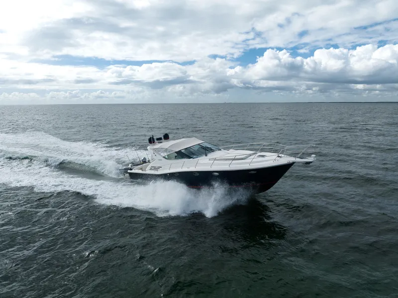 Slide: The Image of 2001 Uniesse 48 Open yacht cruising on open sea under cloudy sky. - 1