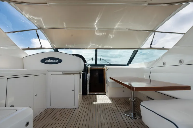 Slide: The Image of 2001 Uniesse 48 Open yacht interior with sleek design and wooden flooring. - 11