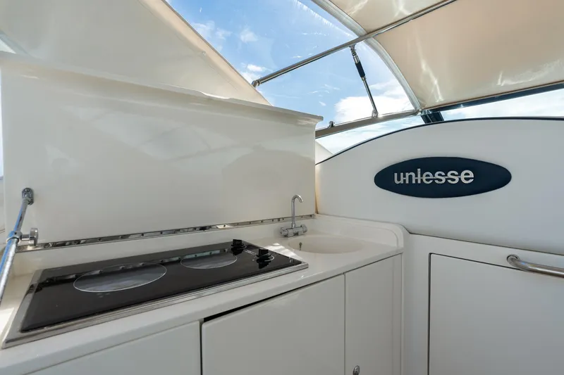 Slide: The Image of Interior view of 2001 Uniesse 48 Open yacht with kitchenette and sleek design. - 12