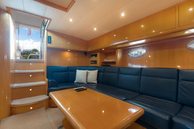 Slide: The Image of Luxurious interior of 2001 Uniesse 48 Open yacht with blue seating and wooden accents. - 14