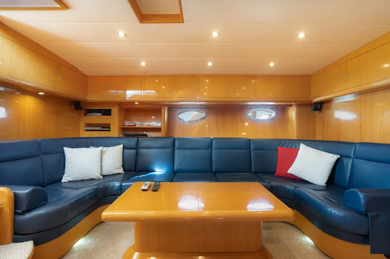 Slide: The Image of Luxurious interior of 2001 Uniesse 48 Open yacht with blue seating and wooden accents. - 15