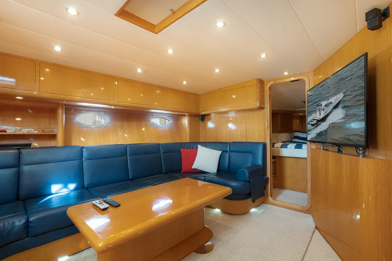 Slide: The Image of Luxurious interior of 2001 Uniesse 48 Open yacht with blue seating and wood finishes. - 17