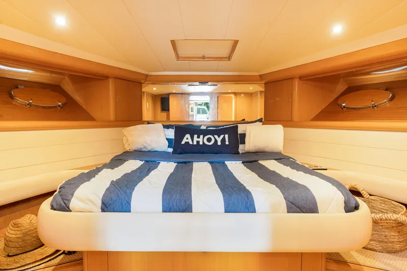 Slide: The Image of Luxurious cabin interior of 2001 Uniesse 48 Open yacht with striped bedding. - 18