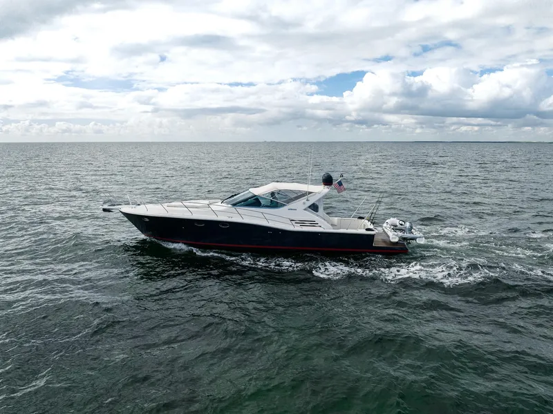 Slide: The Image of 2001 Uniesse 48 Open yacht cruising on open sea under cloudy sky. - 2