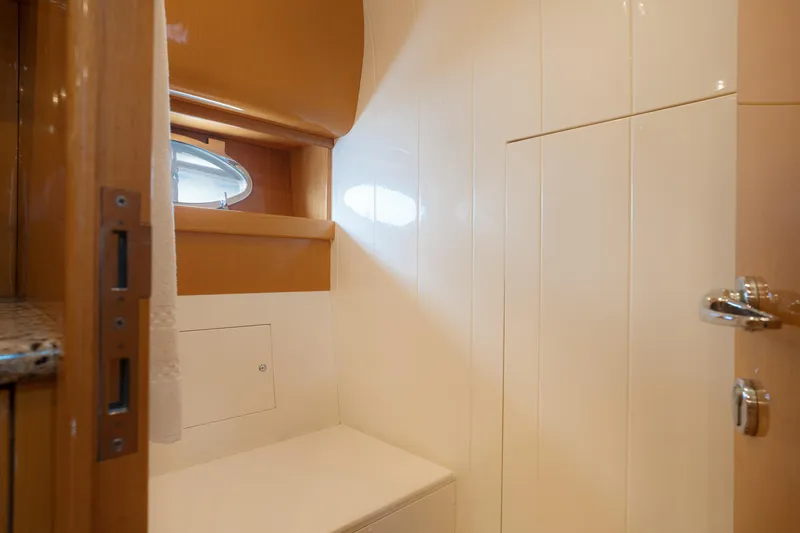 Slide: The Image of Interior of 2001 Uniesse 48 Open yacht bathroom with porthole and wooden accents. - 21