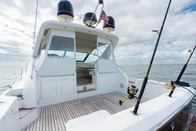 Slide: The Image of 2001 Uniesse 48 Open yacht with fishing rods, spacious deck, and ocean view. - 24