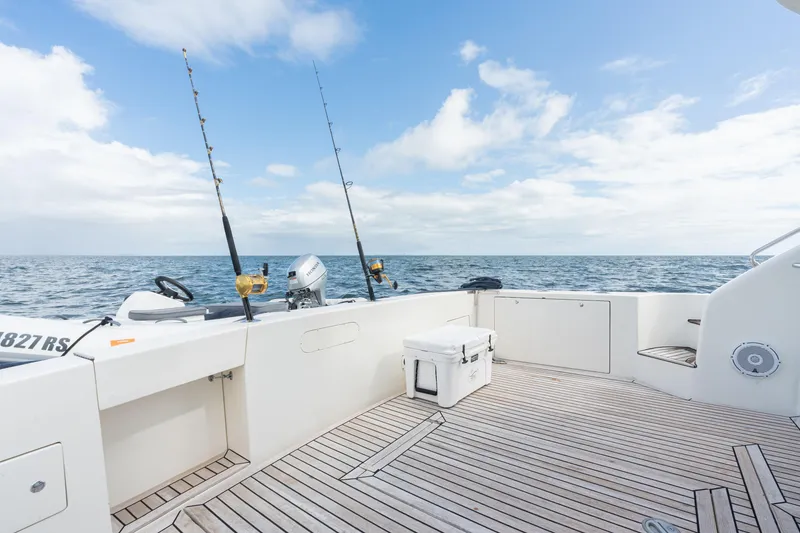 Slide: The Image of Uniesse 48 Open 2001 yacht deck with fishing rods and ocean view. - 25