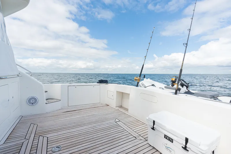 Slide: The Image of Spacious deck of 2001 Uniesse 48 Open yacht with fishing rods, ocean view. - 26